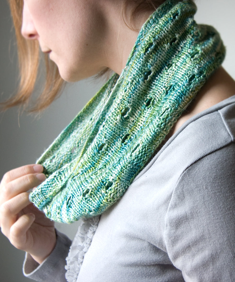 Knitted cowl in silk with eyelets